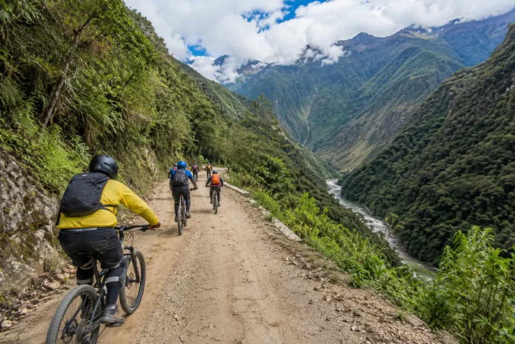 Group cycling the Inca Jungle Trek route toward Machu Picchu, Cusco Peru