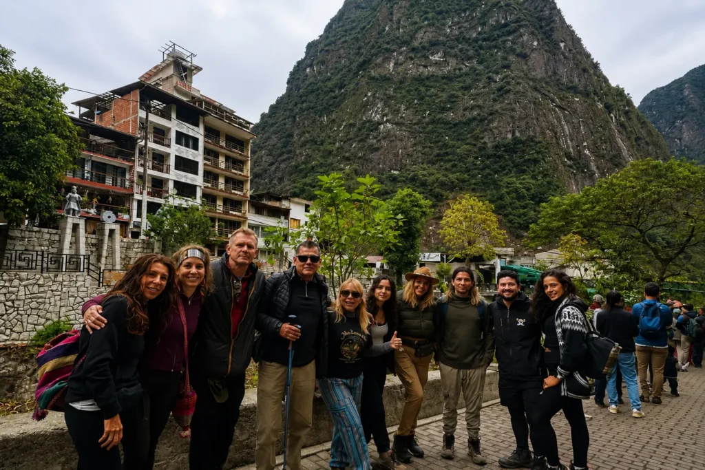 Happy group of international travelers arriving at the Inca citadel entrance gate