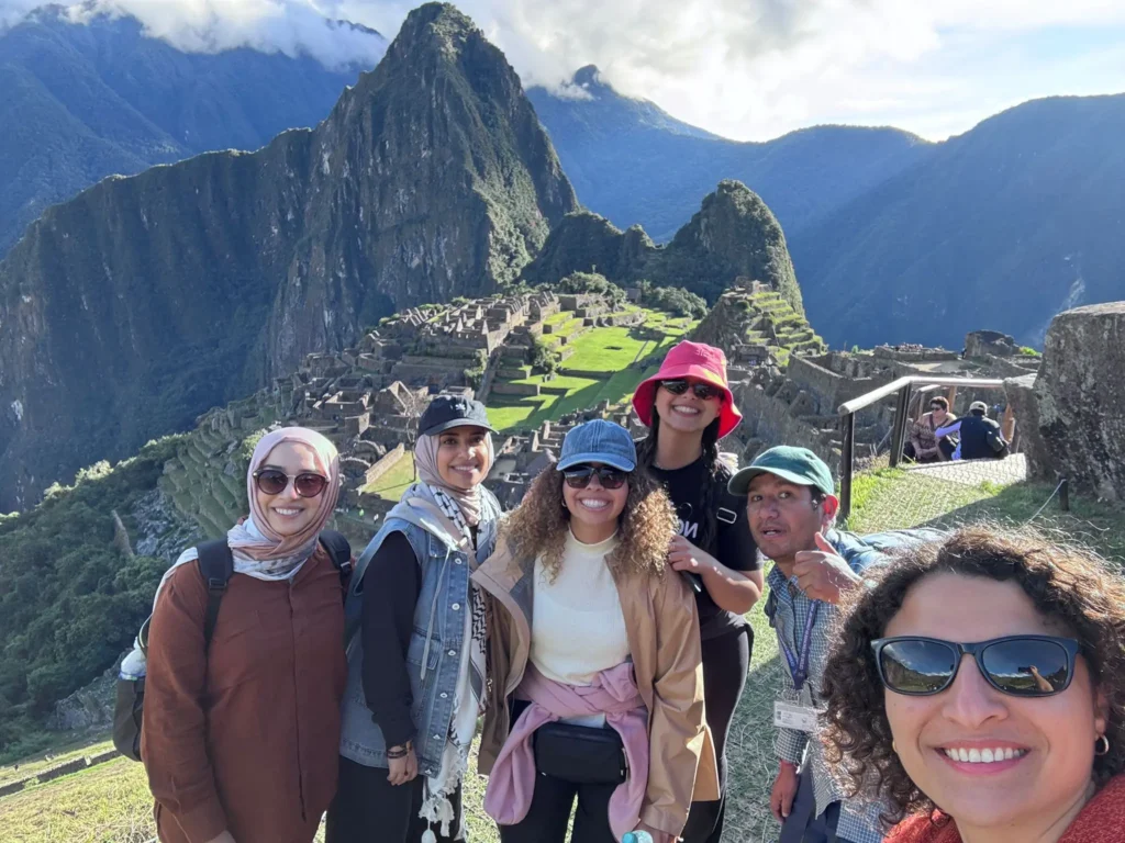Salkantay Trek completion — group of trekkers celebrating arrival at Machu Picchu citadel after 4-day adventure