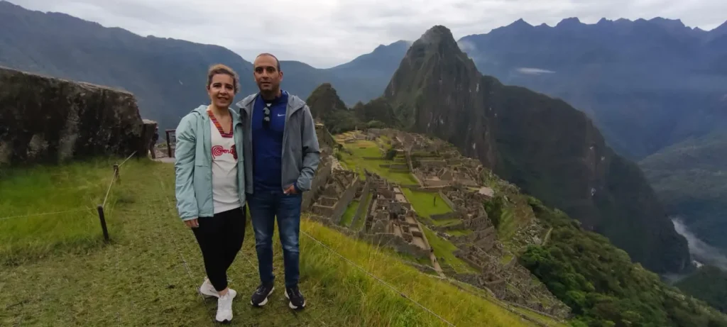 Machu Picchu reservation — panoramic sunrise view of the Inca citadel with Huayna Picchu mountain