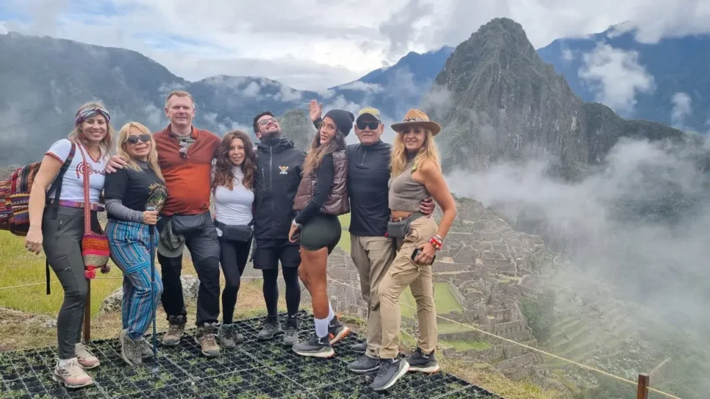 Salkantay Trek group at Abra Salkantay pass — trekkers with Peruvian Cusco Travel Tour banner at 4650 meters