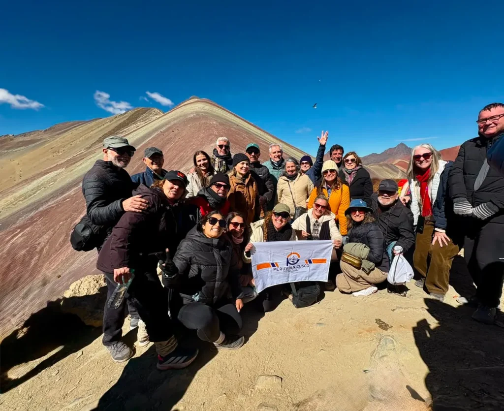 Tourist enjoying view of Rainbow Mountain Vinicunca with alpaca
